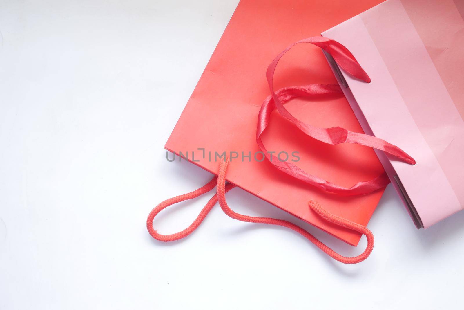 red color gift bag on white background top view..