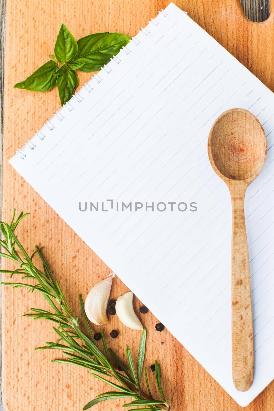 Recipe concept. Blank sheet of paper on a wooden board with spices