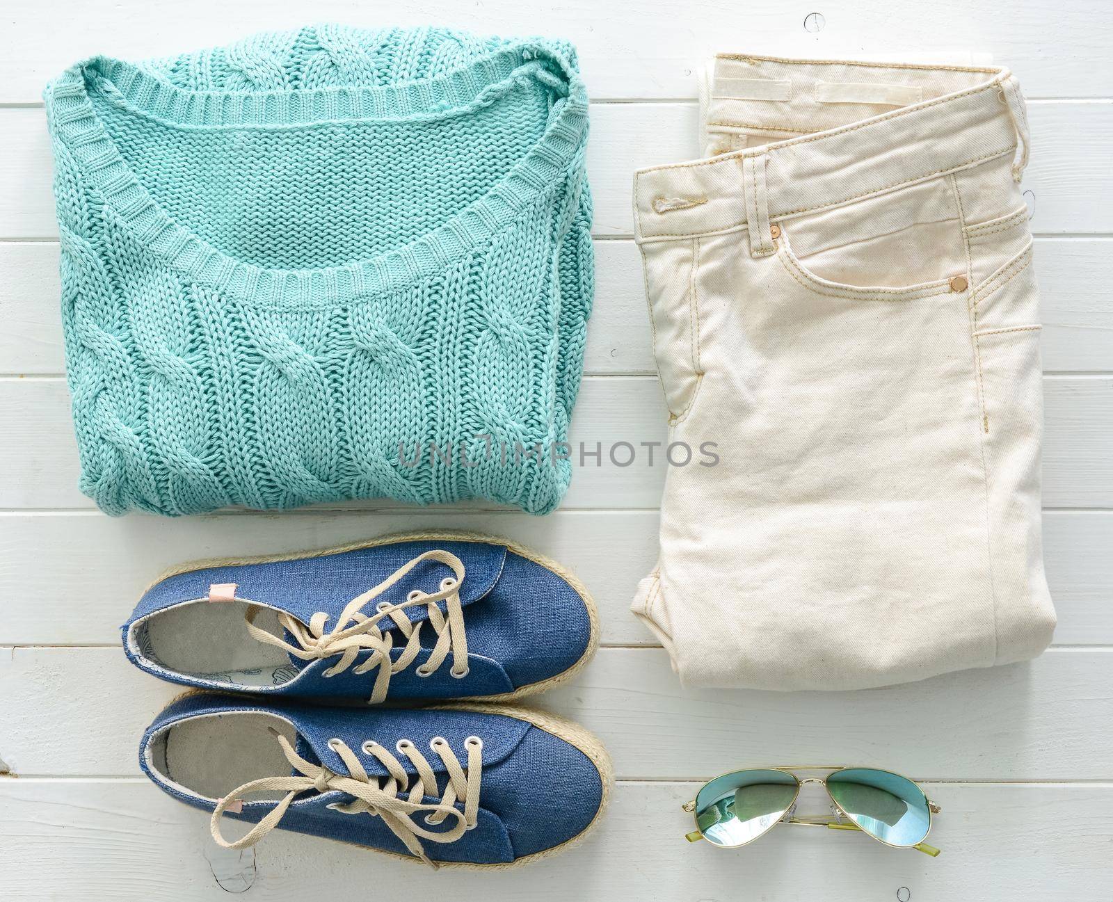 set of folded casual women clothes on wooden table top view