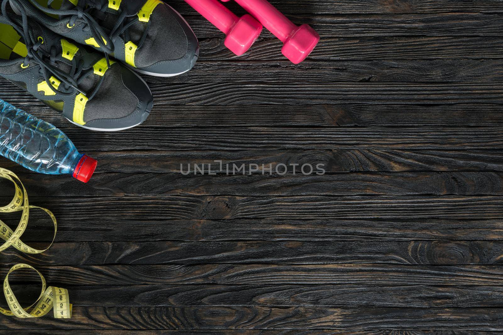 sport fitness items on dark wooden background with empty text space