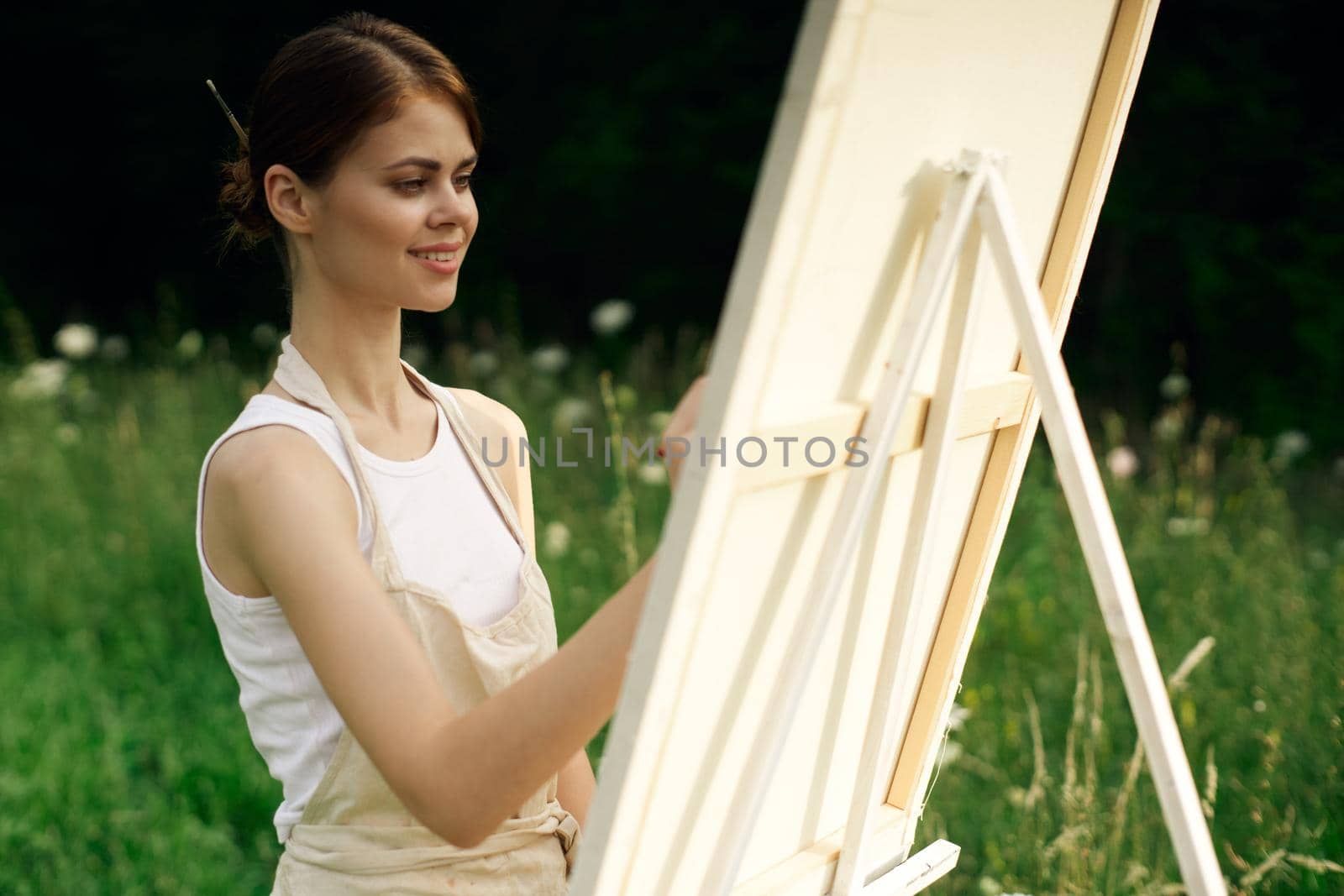 woman artist paints a picture on nature art hobby. High quality photo