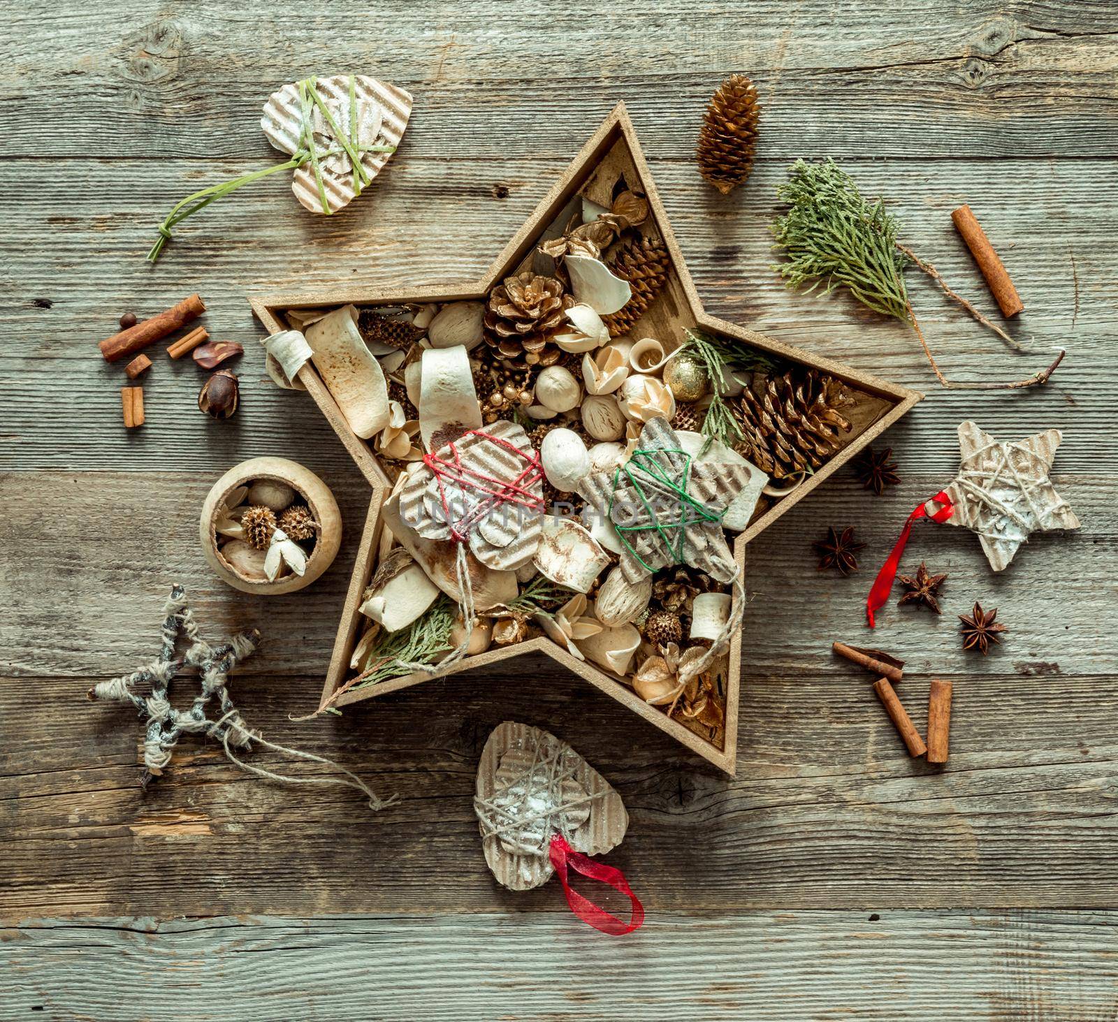 christmas decorations in a star shaped box on wooden background