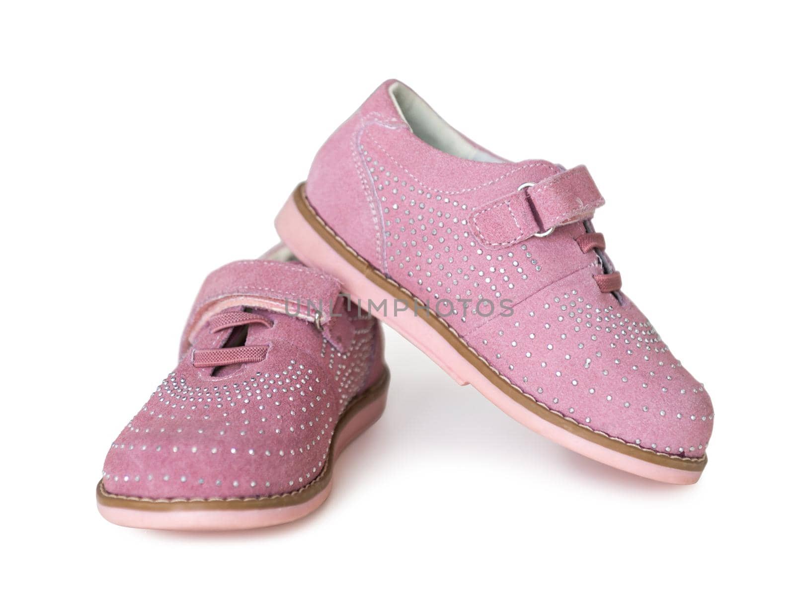 lovely pink childish shoes with laces and clasp isolated on white background