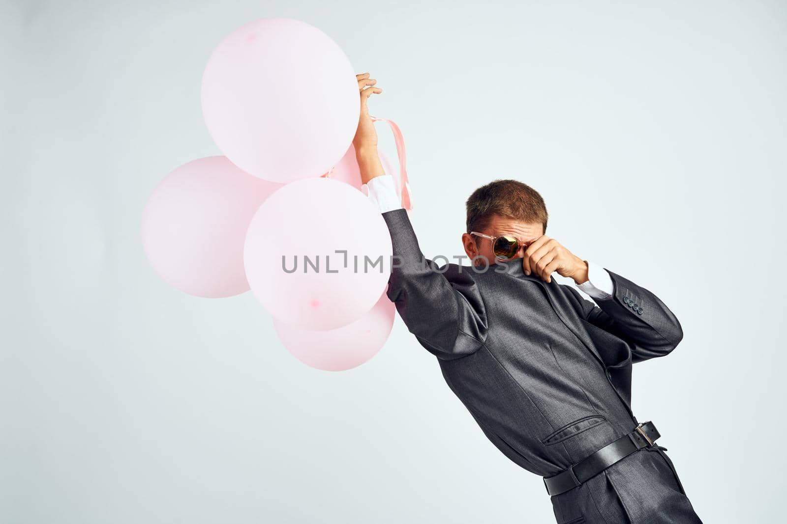 business man in a suit sunglasses office balloons. High quality photo