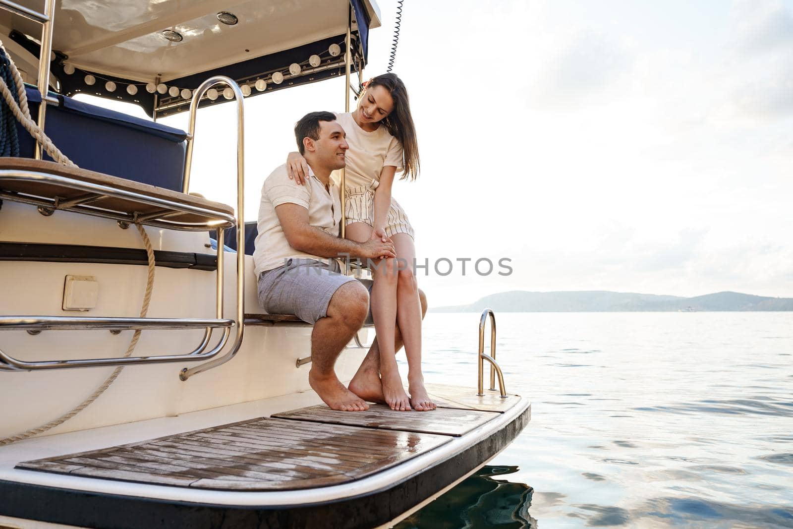 Loving couple spending time on a yacht at the open sea