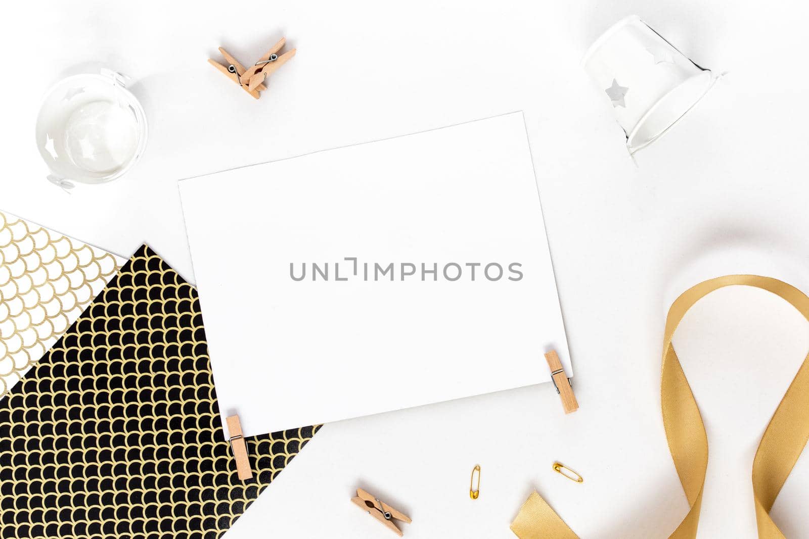 Top view on Beautiful greeting card idea with area for your text with golden ribbon, wooden clothespins copyspace, topview, mockup, flatlay.