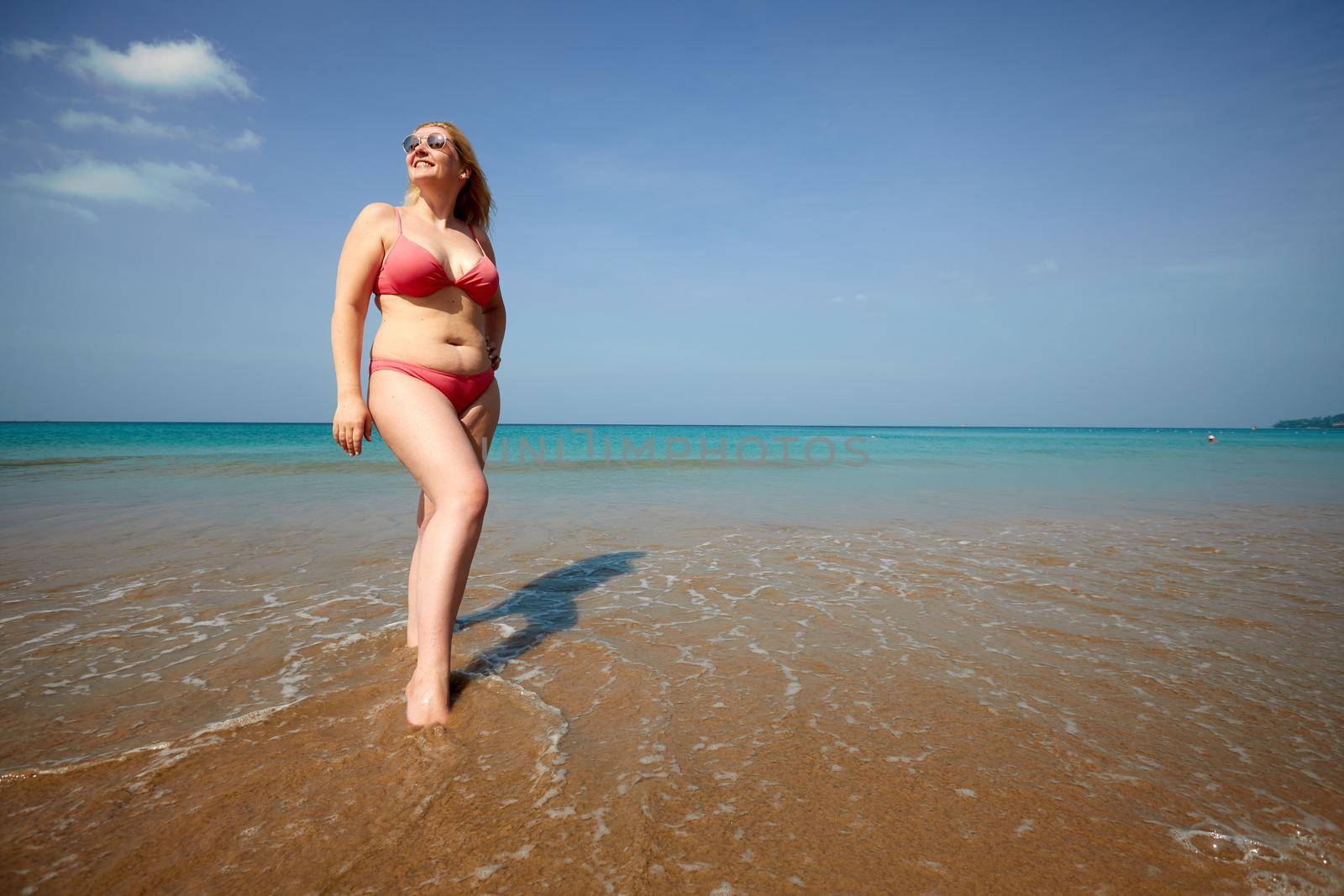 Plus size female tourist enjoying vacation on sandy seacoast by Demkat