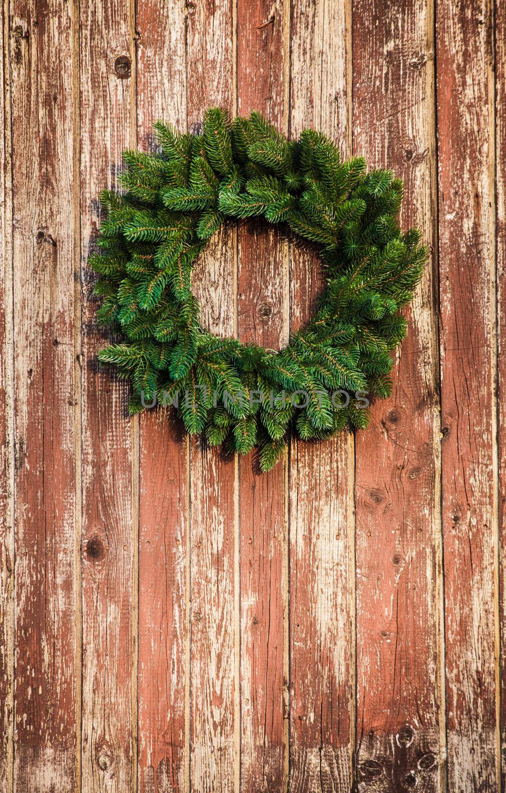 Christmas wreath on the shabby wooden door. Christmas holiday background with copy space