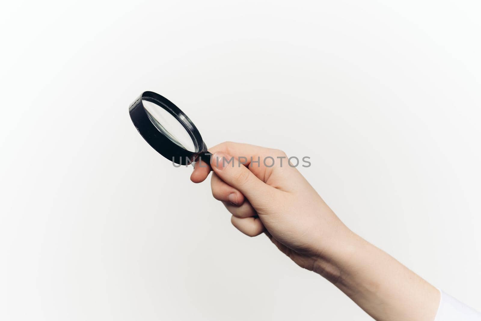 magnifier in hand tool search lcd light background. High quality photo