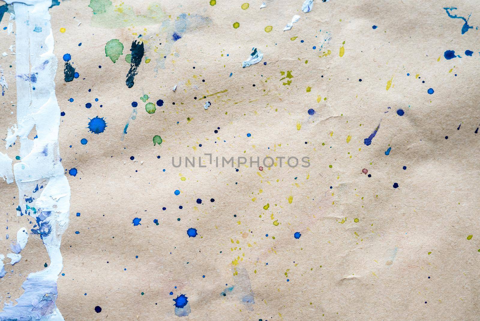 Abstract drawing of strokes and droplets at watercolor paper