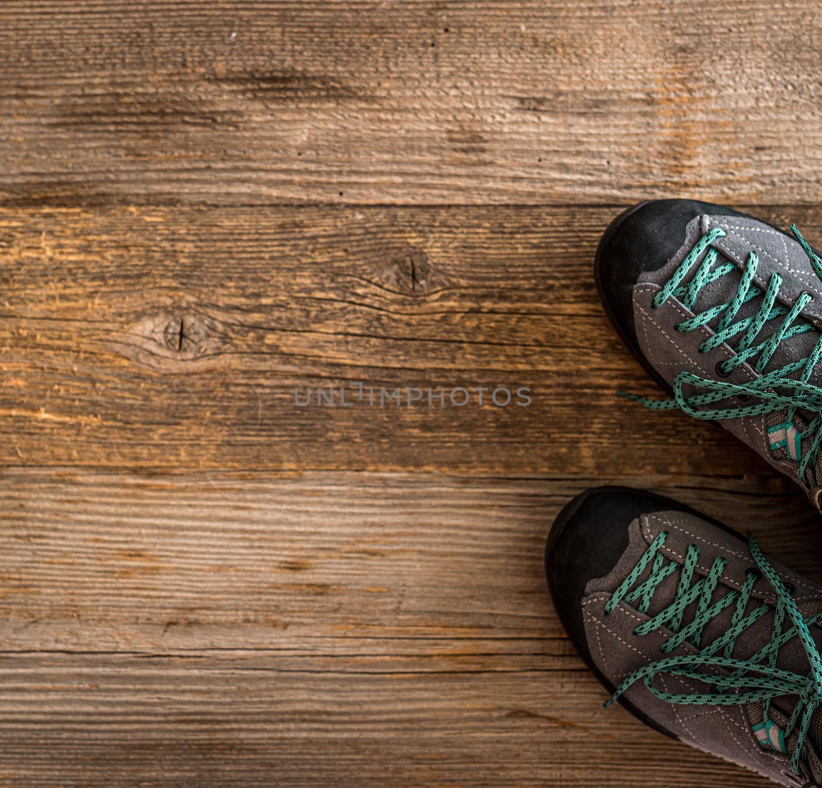 Top view of trekking equipment in corner on wooden background with copy space