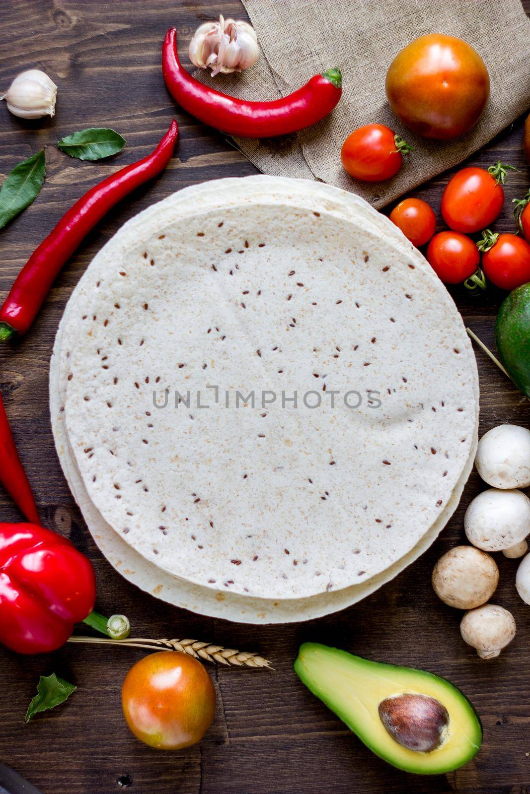 Tortillas - corn bread with vegetables on wooden table