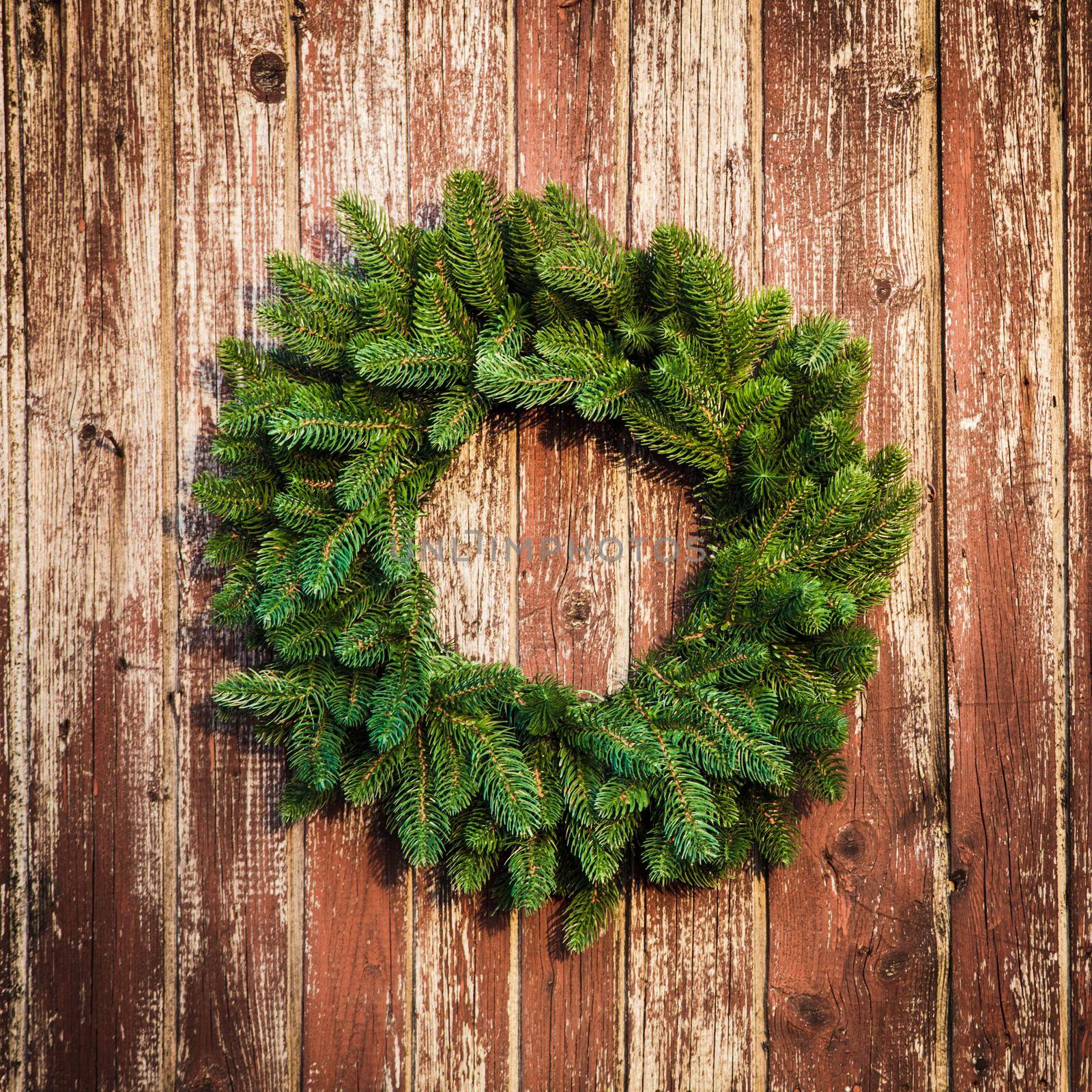 Christmas wreath on the shabby wooden door. Christmas holiday background with copy space