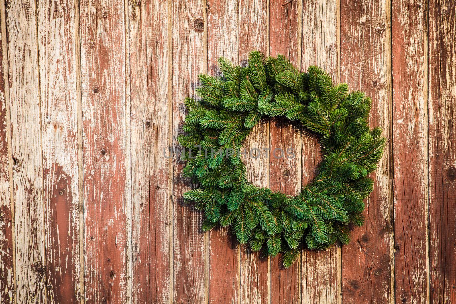 Christmas wreath on the shabby wooden door. Christmas holiday background with copy space