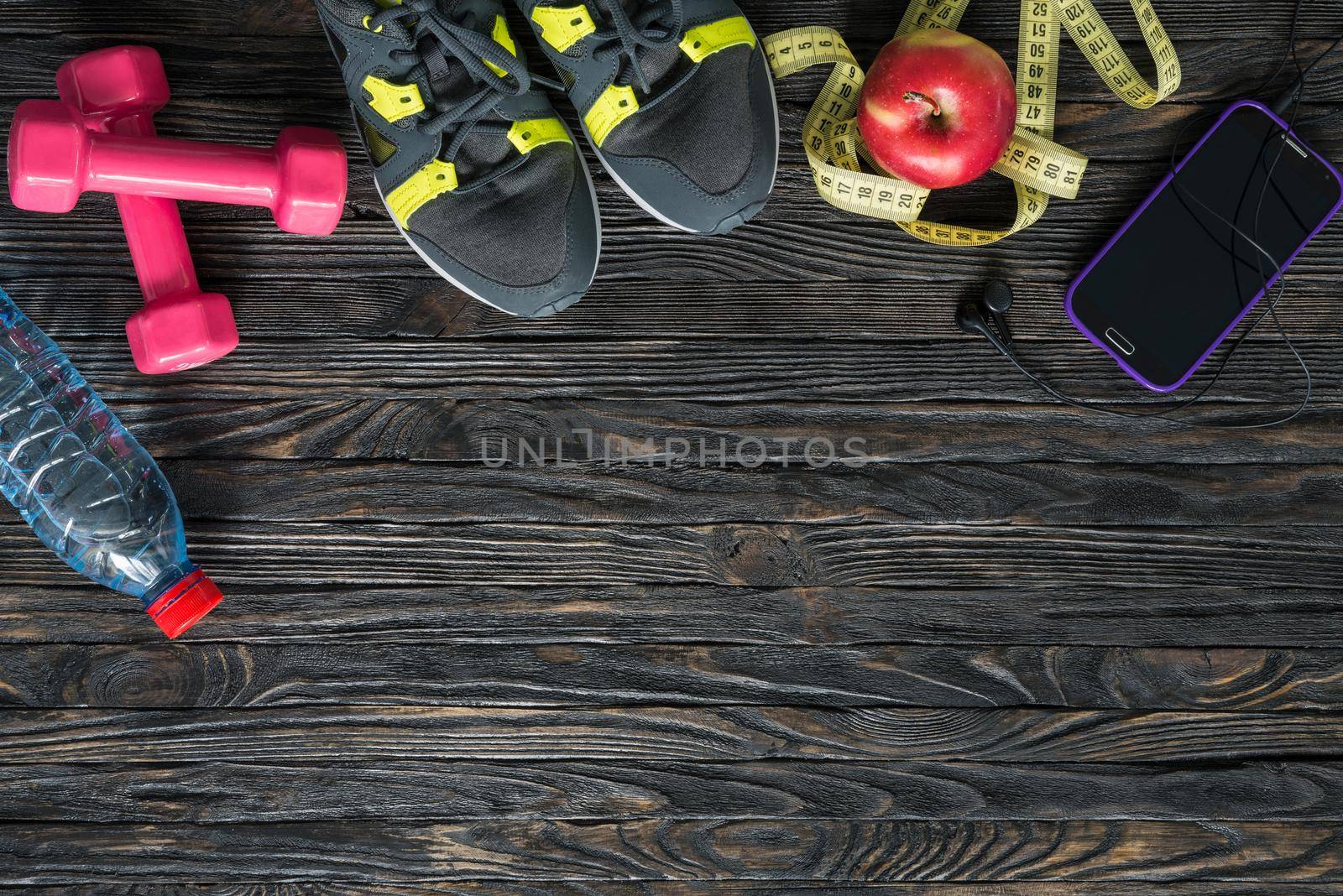 sport fitness items on dark wooden background with empty text space