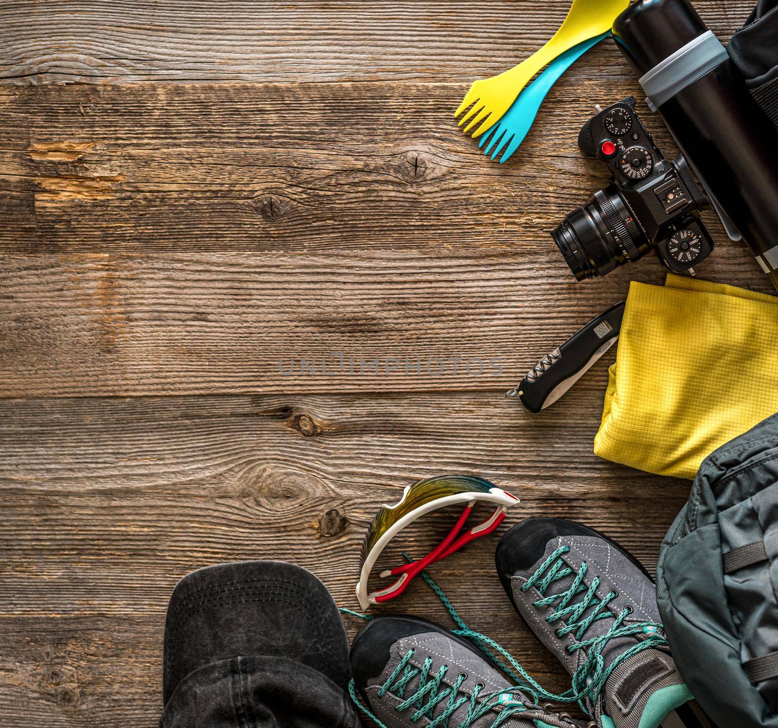 Top view of trekking equipment in corner on wooden background with copy space