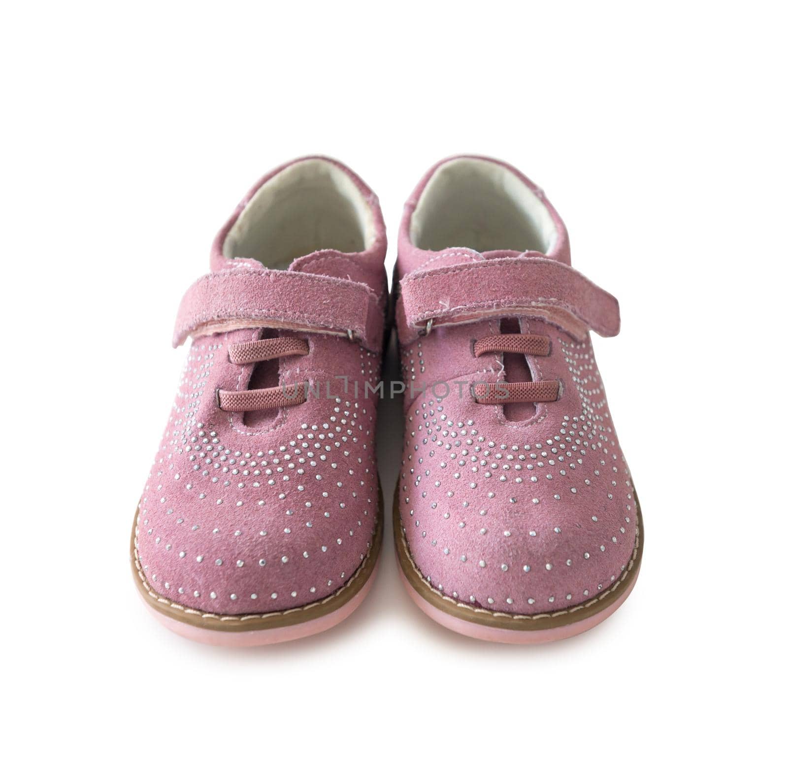 lovely pink childish shoes with laces and clasp isolated on white background