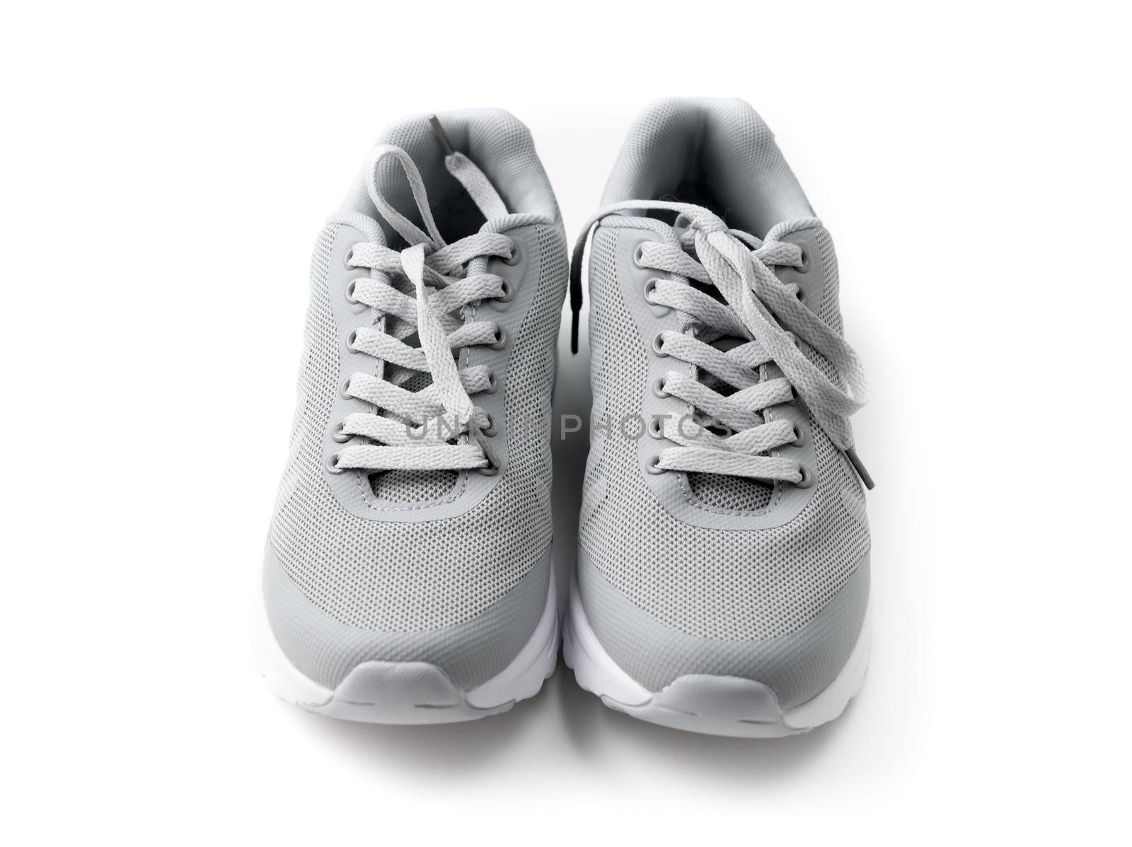 Gray cozy running shoes sitting on wood by tan4ikk1