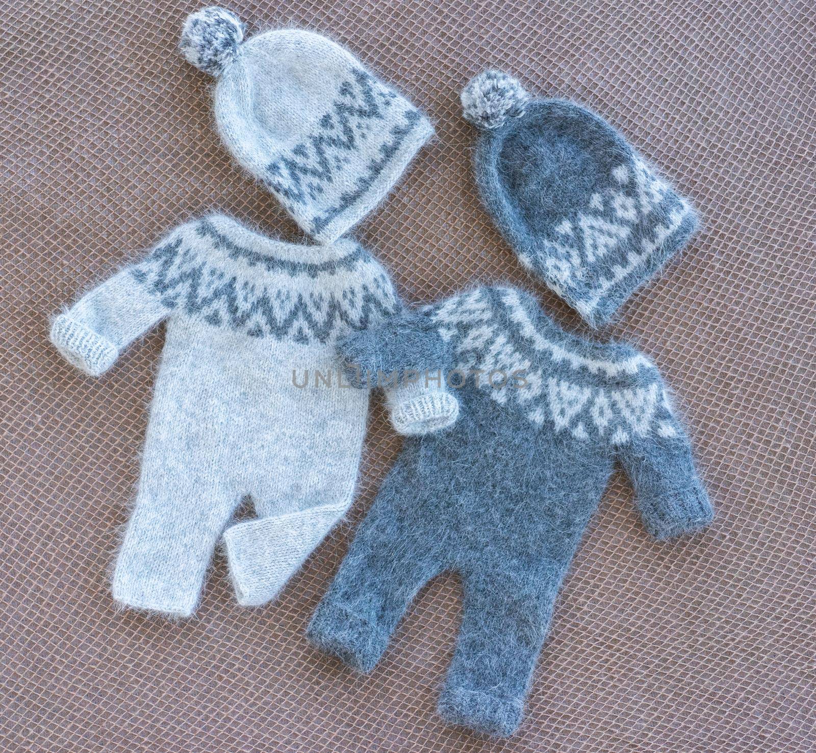 knitted newborn baby clothes composed on a fabric