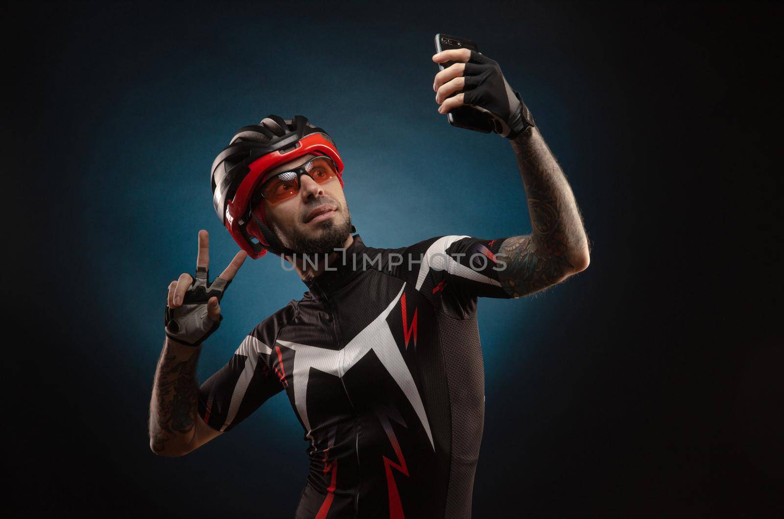 guy is a cyclist in a Bicycle helmet takes a selfie by Rotozey