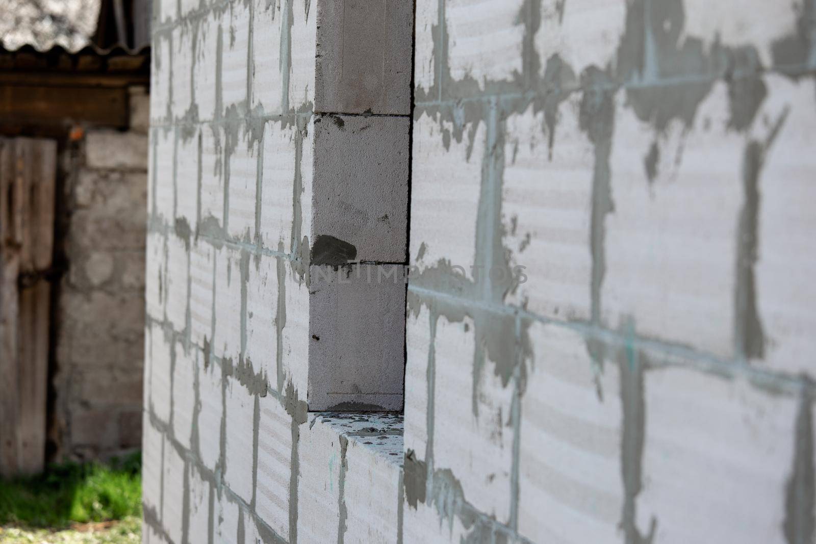 Masonry or bricklaying work. The concrete blocks for wall in the construction site