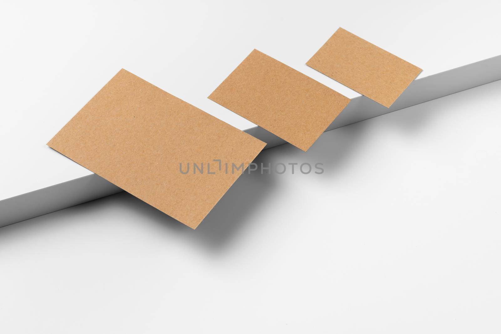 Empty craft business cards on white background. Close up.