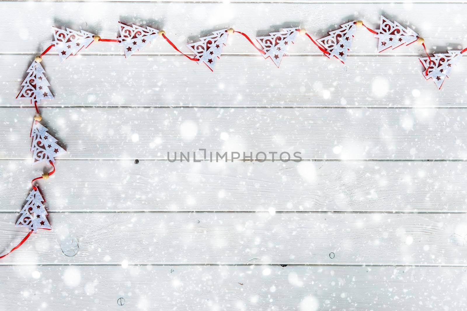 wooden planks under snow with christmas decorations top view