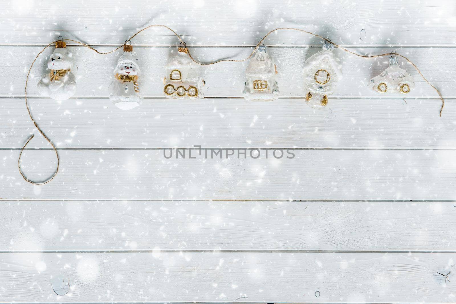 white wooden planks under snow and christmas decorations by tan4ikk1
