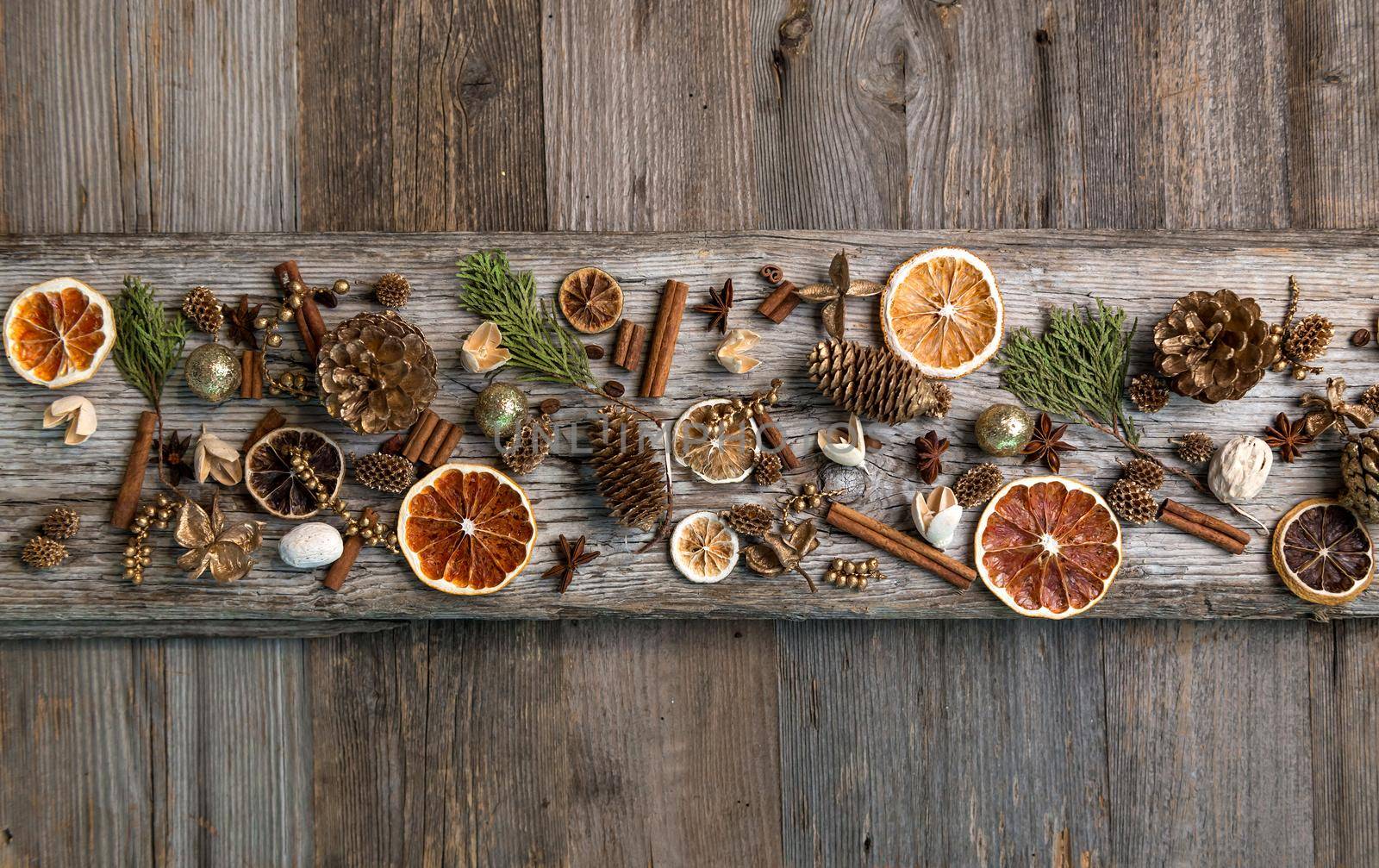 Christmas decorations on an old wooden background with cinnamon and dried orange slices