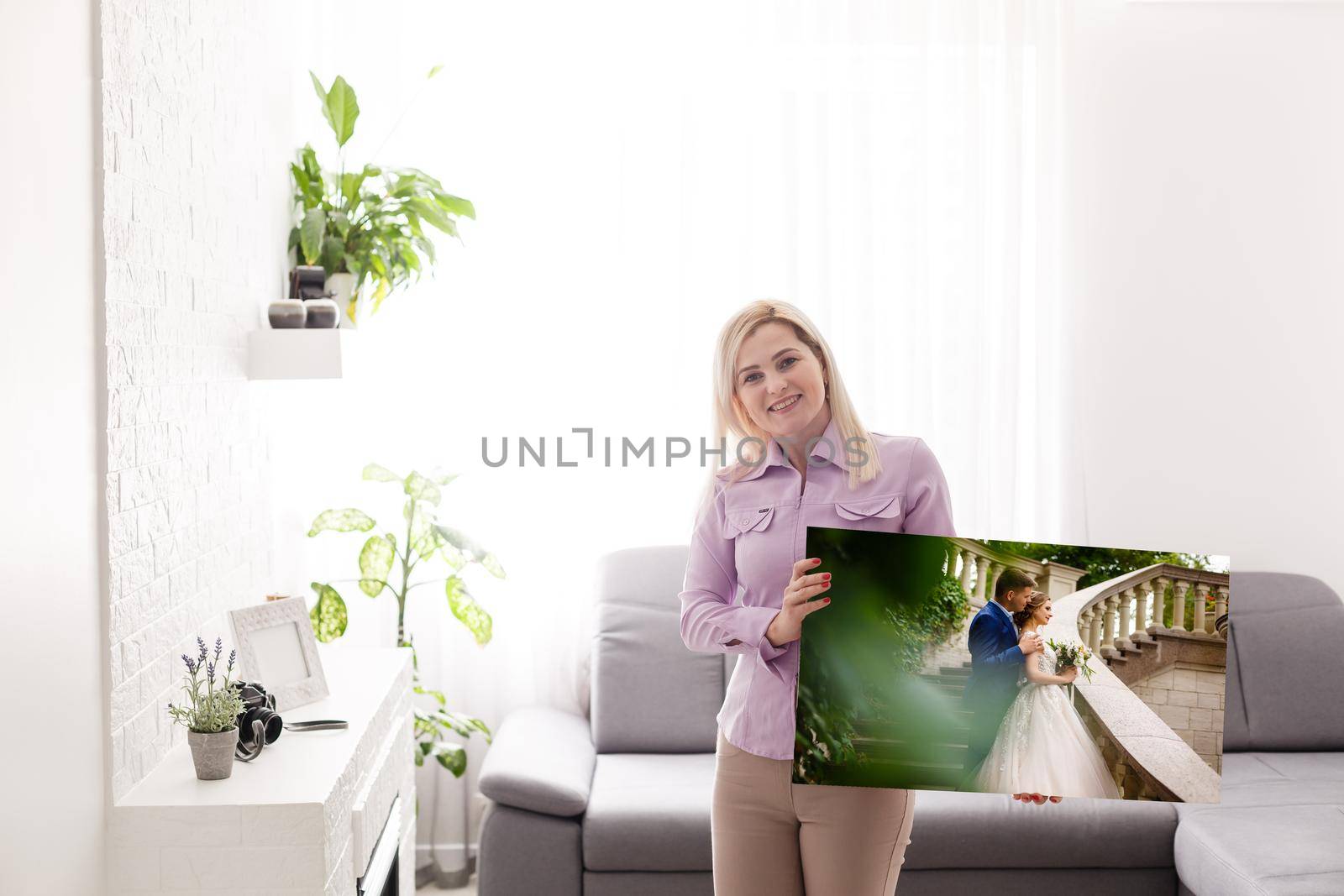 Woman holding wedding photography photo canvas print with gallery wrap