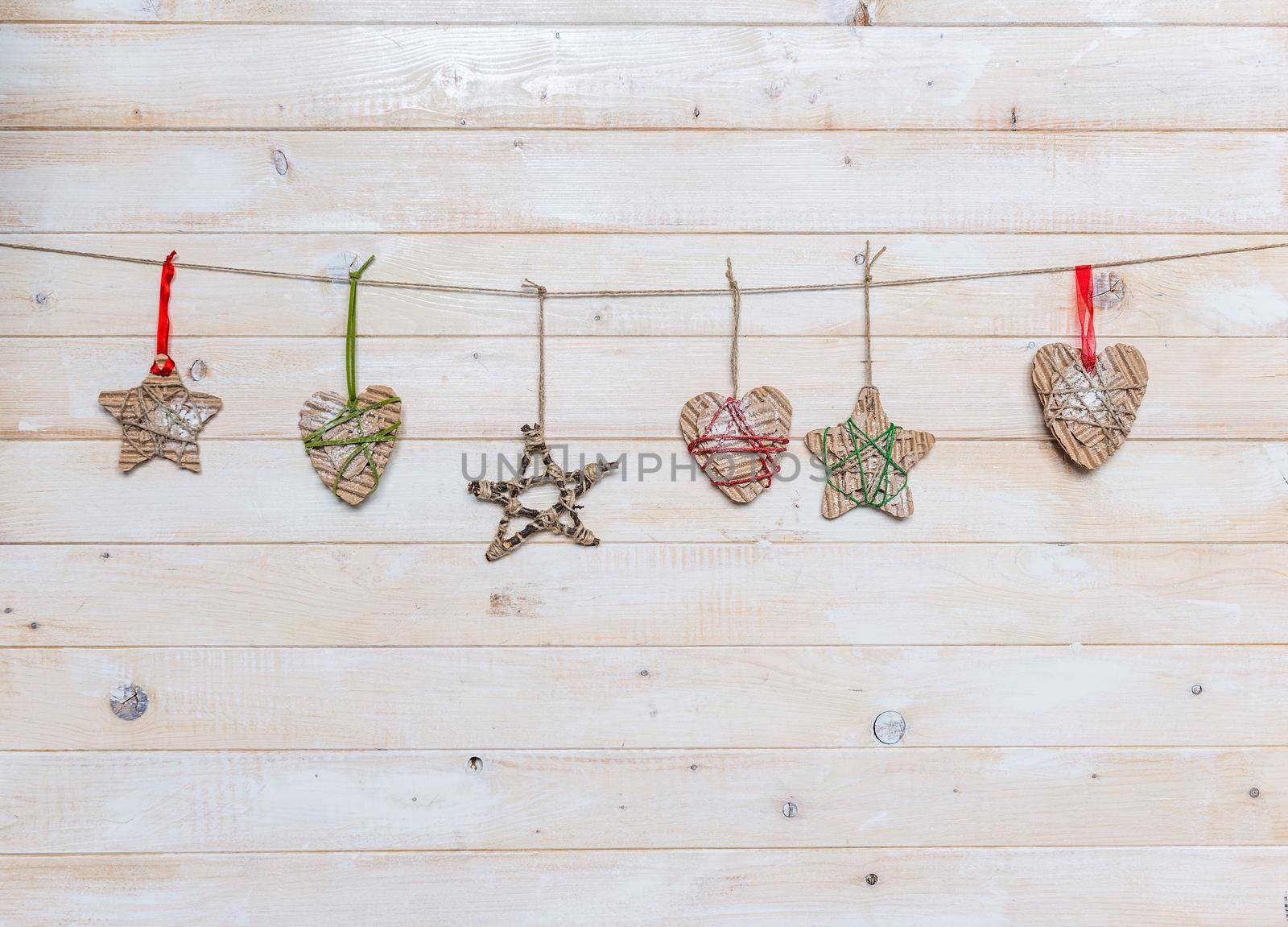 christmas handmade toys on light wooden background with text space