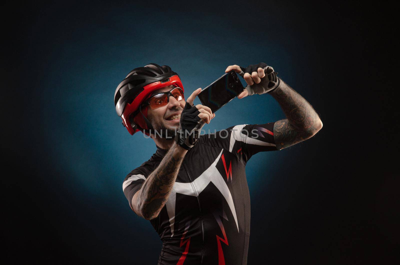 guy is a cyclist in a Bicycle helmet takes a selfie by Rotozey