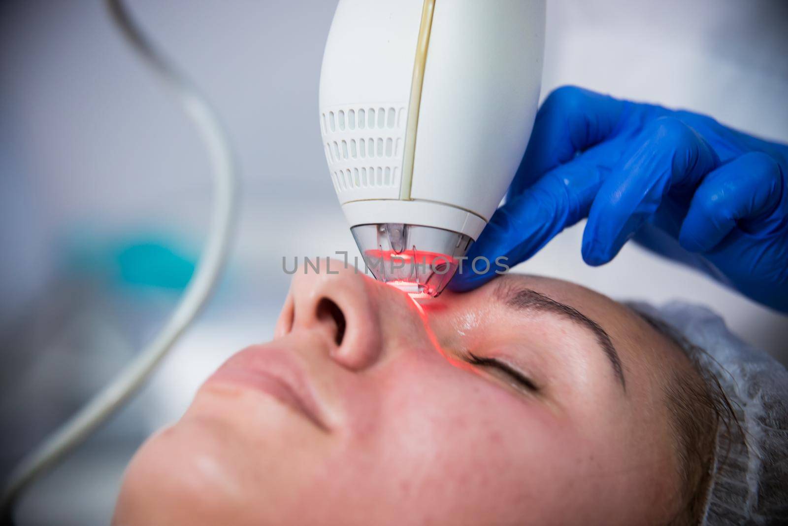 Cosmetology clinic. Pore cleansing procedure. A cosmetologist working with a tool. Close up