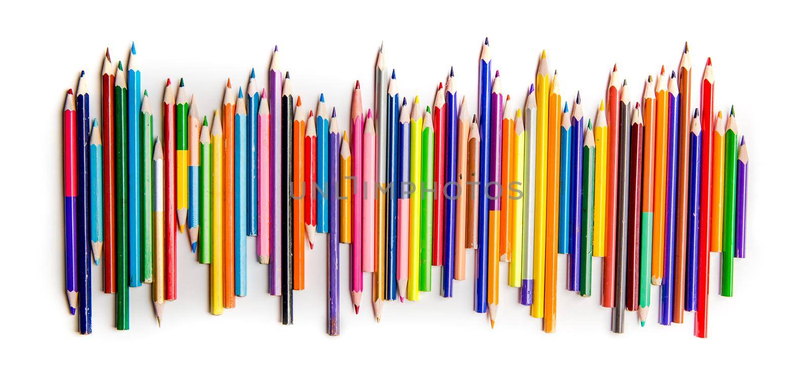 Top view of bright color pencils placed in a row isolated on white background