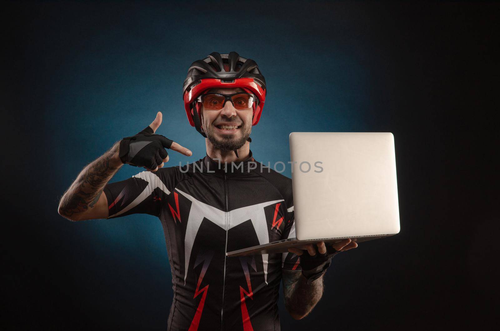 guy-cyclist in a Bicycle helmet with a laptop
