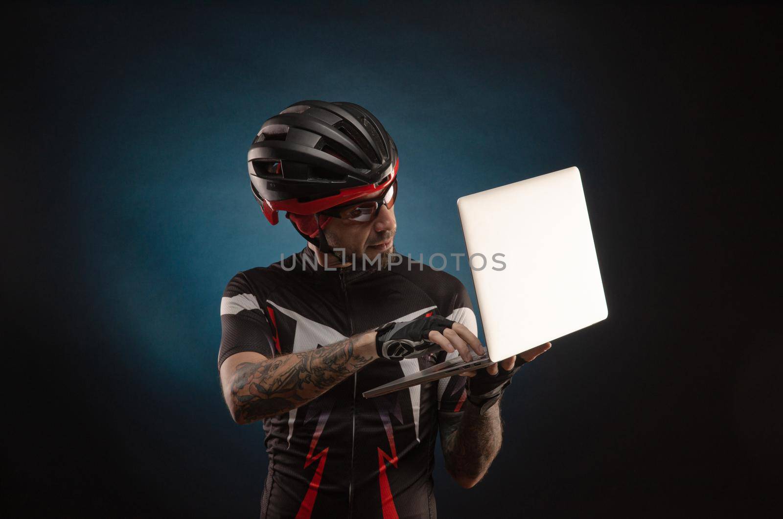 guy-cyclist in a Bicycle helmet with a laptop