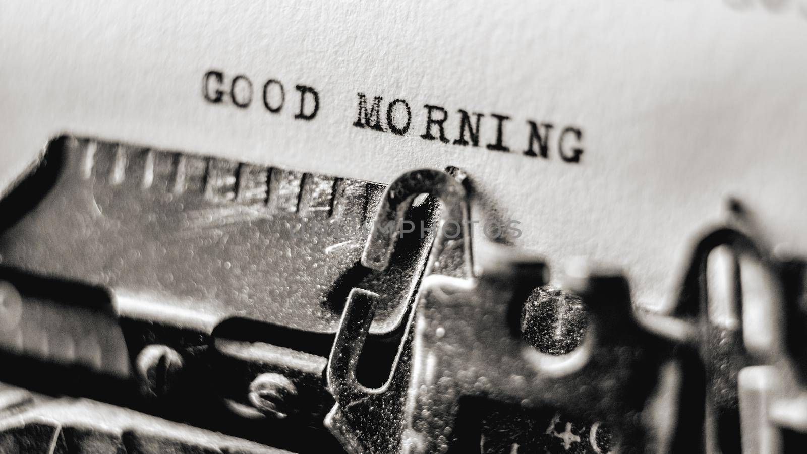 Text Good morning printed in old style on retro typewriter using black inks. Nostalgic typescript