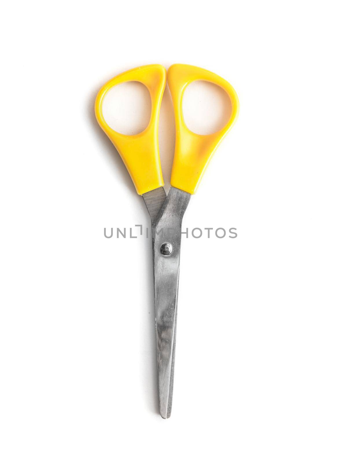 Yellow scissors isolated on a white background