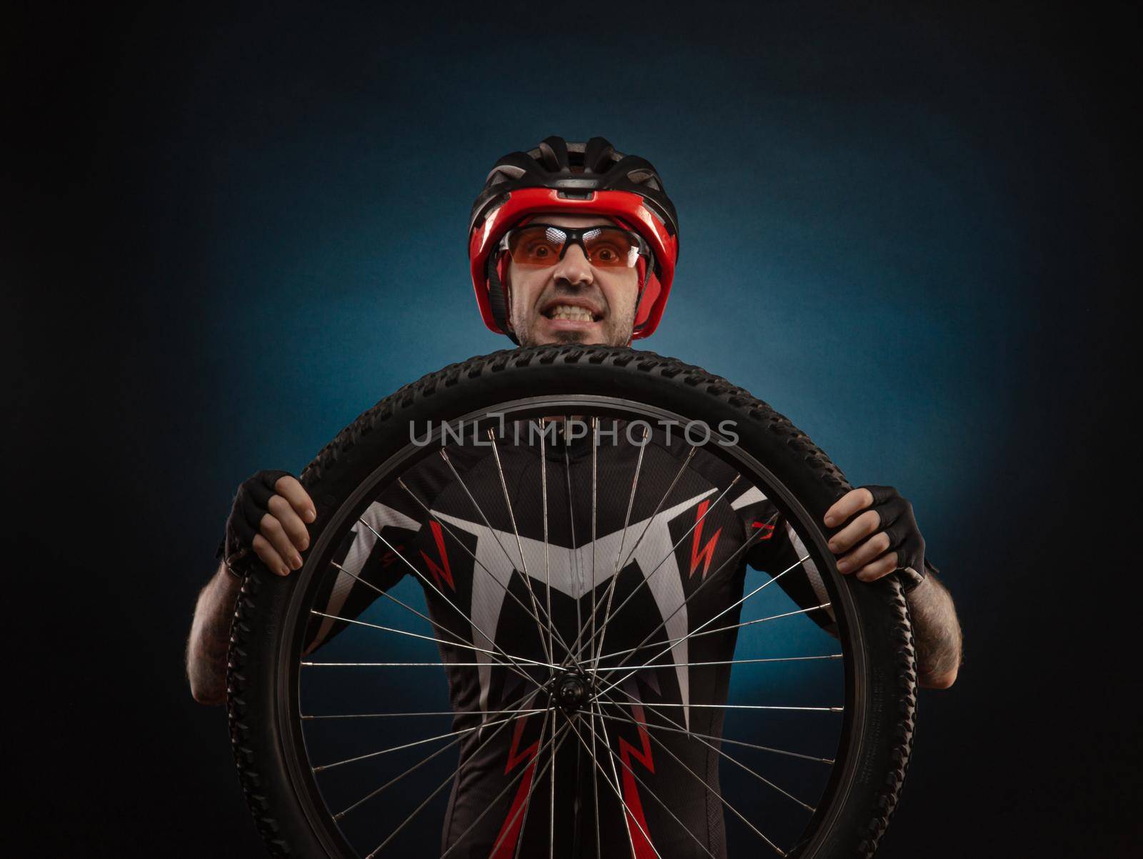 guy-cyclist in a Bicycle helmet with a Bicycle wheel