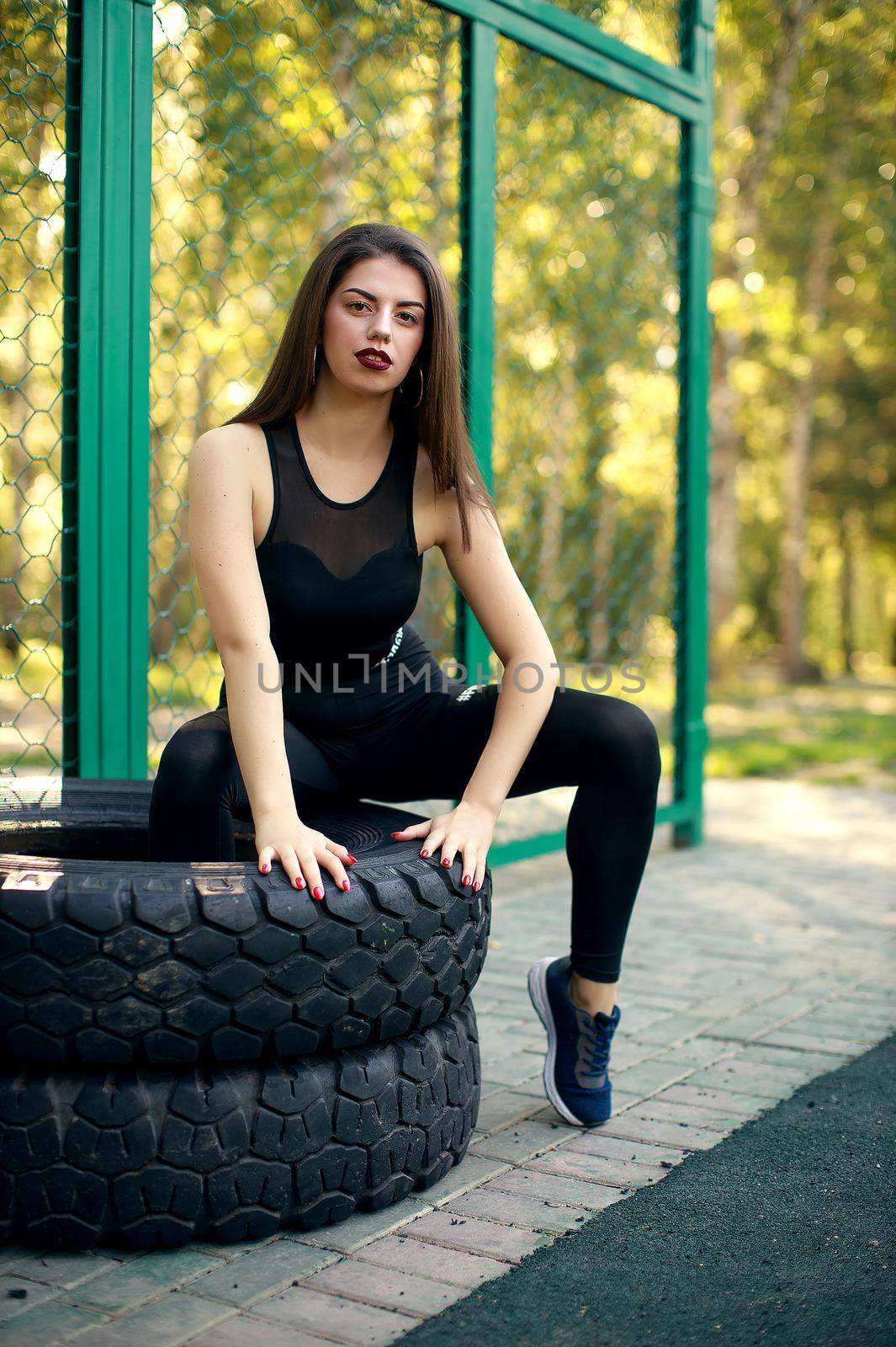 Girl training using sportground young adult woman workout posing Healthy lifestyle