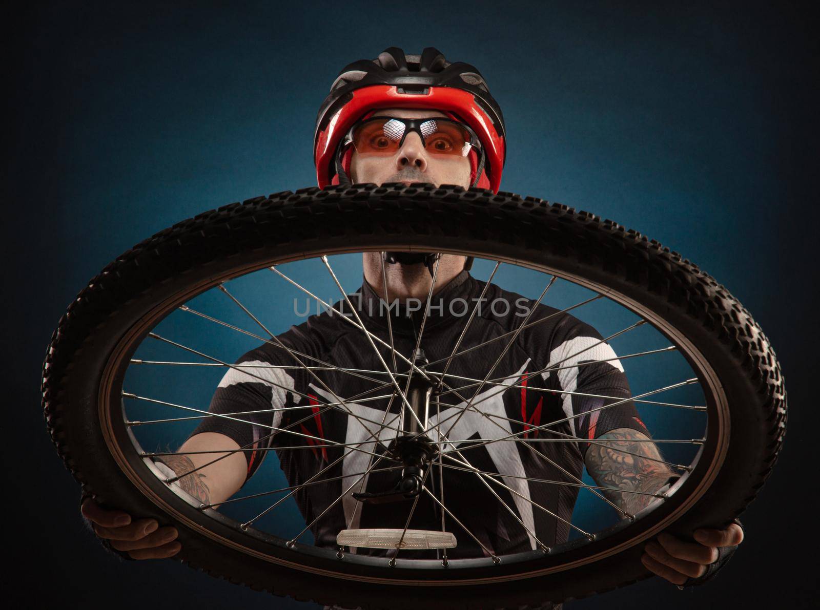 guy-cyclist in a Bicycle helmet with a Bicycle wheel by Rotozey