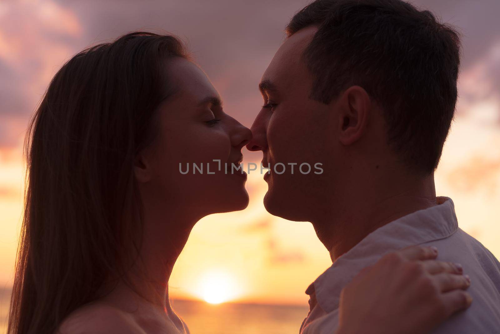 Romantic sensual young couple in love at the sunset by Fabrikasimf