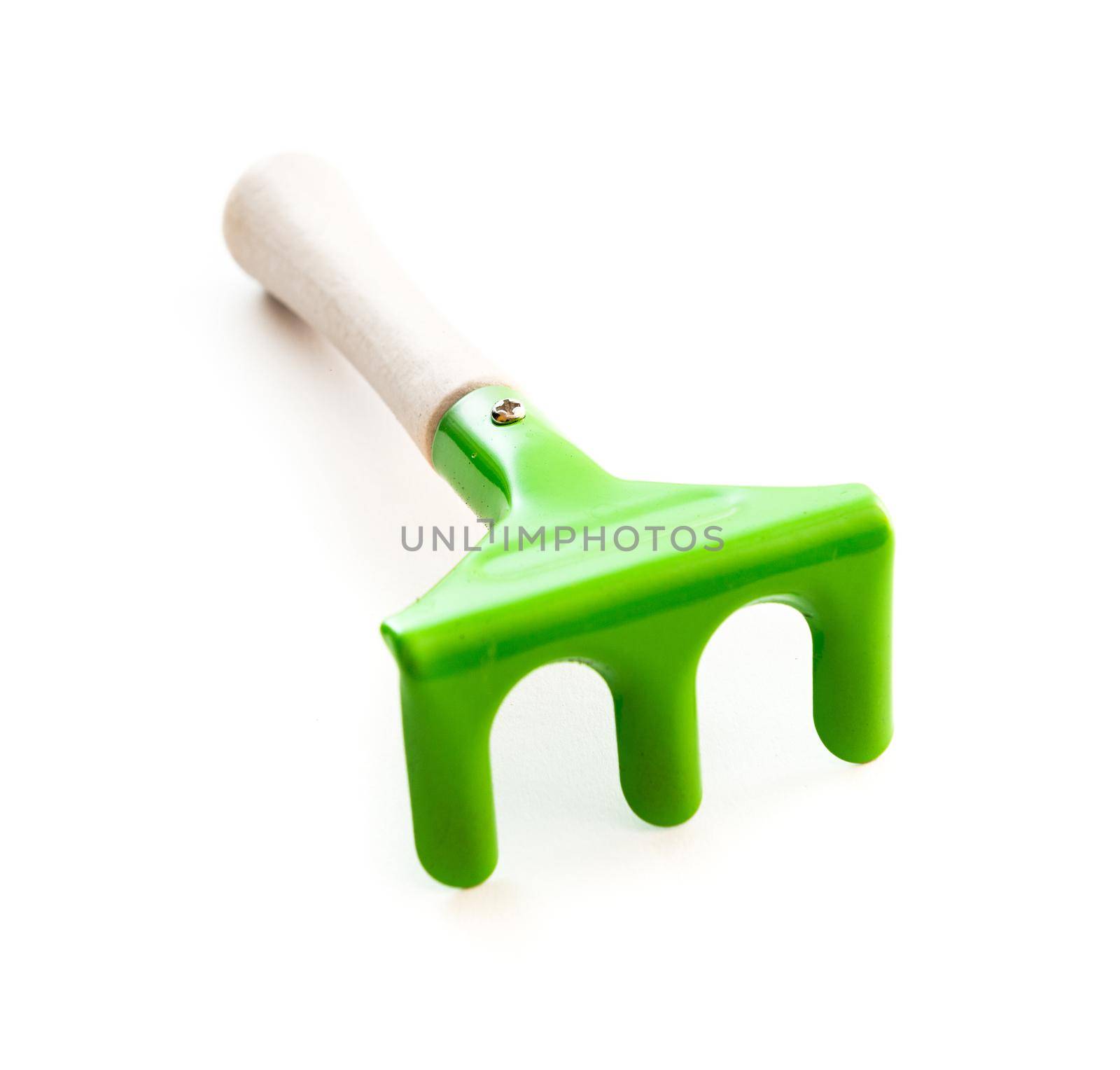 green garden rake is isolated on a white background
