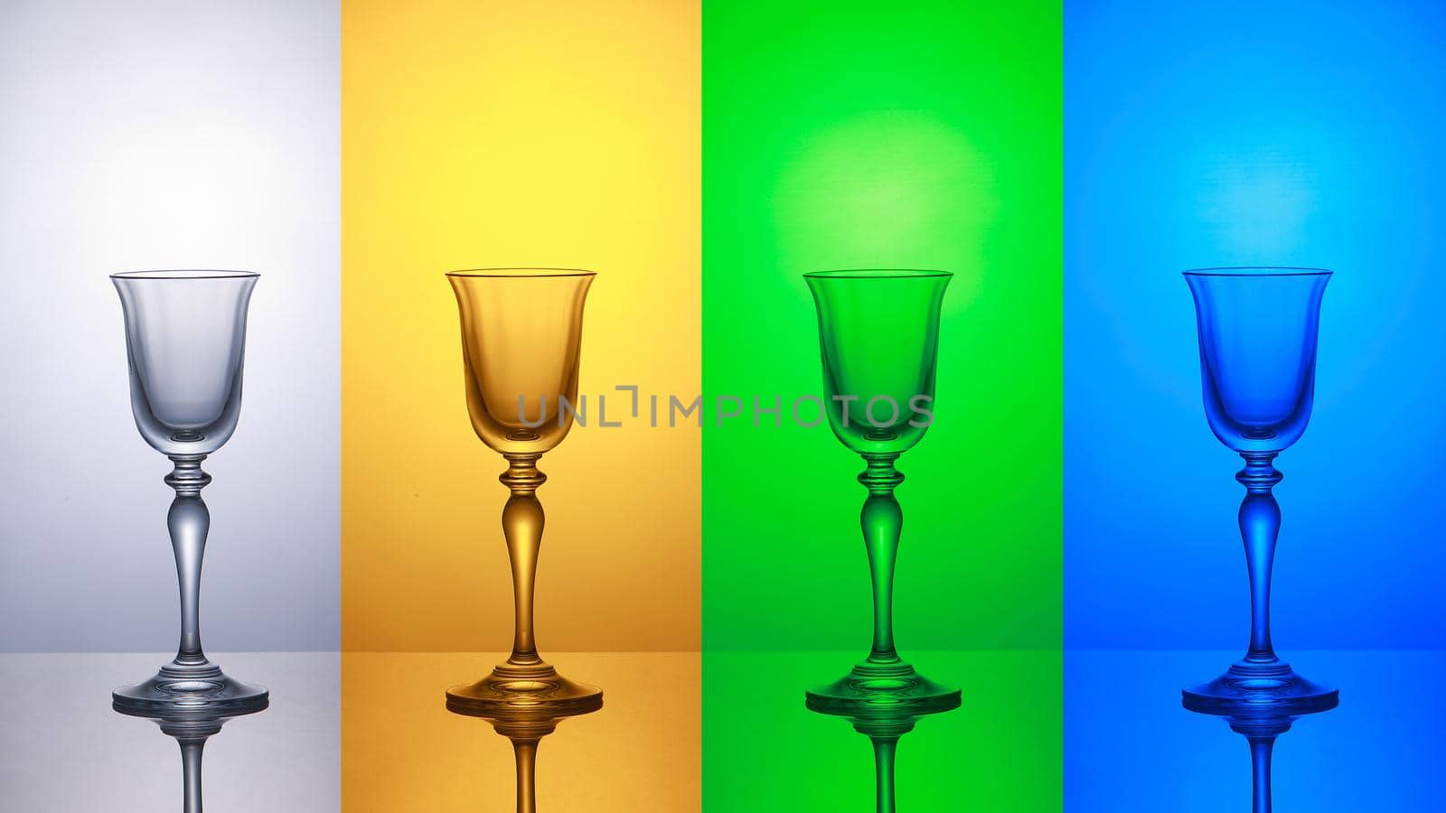 Empty wine glass on a white yellow green blue striped baground