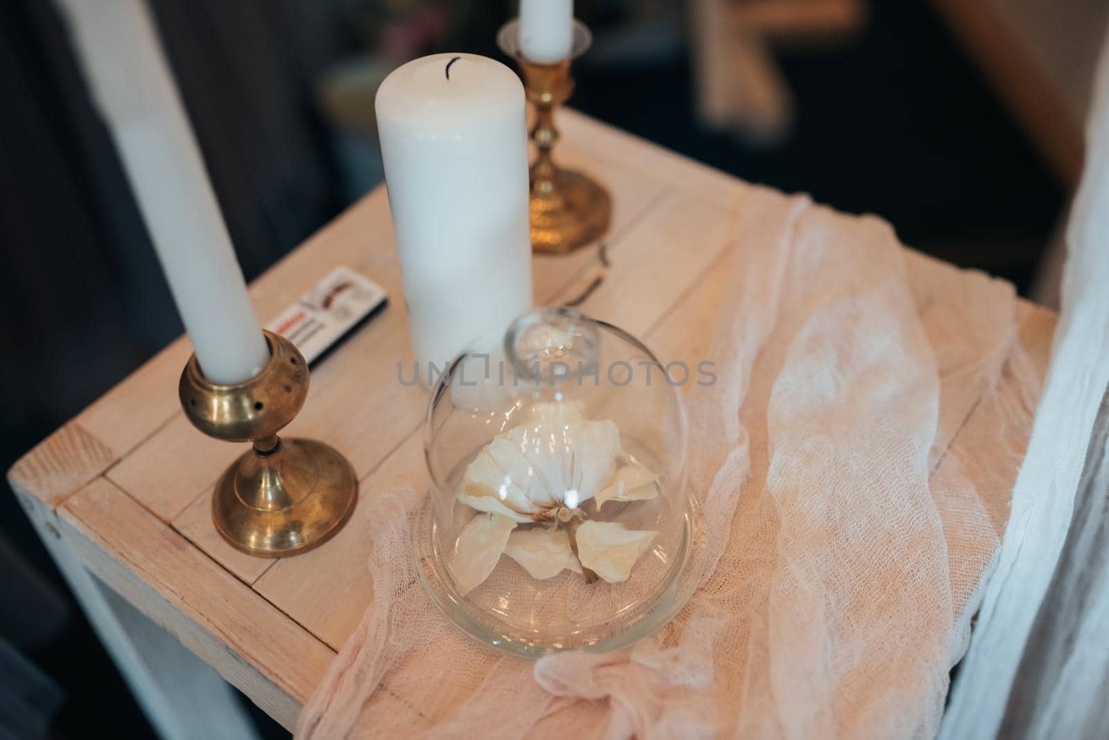 Small wedding table in white with candles and flowers.