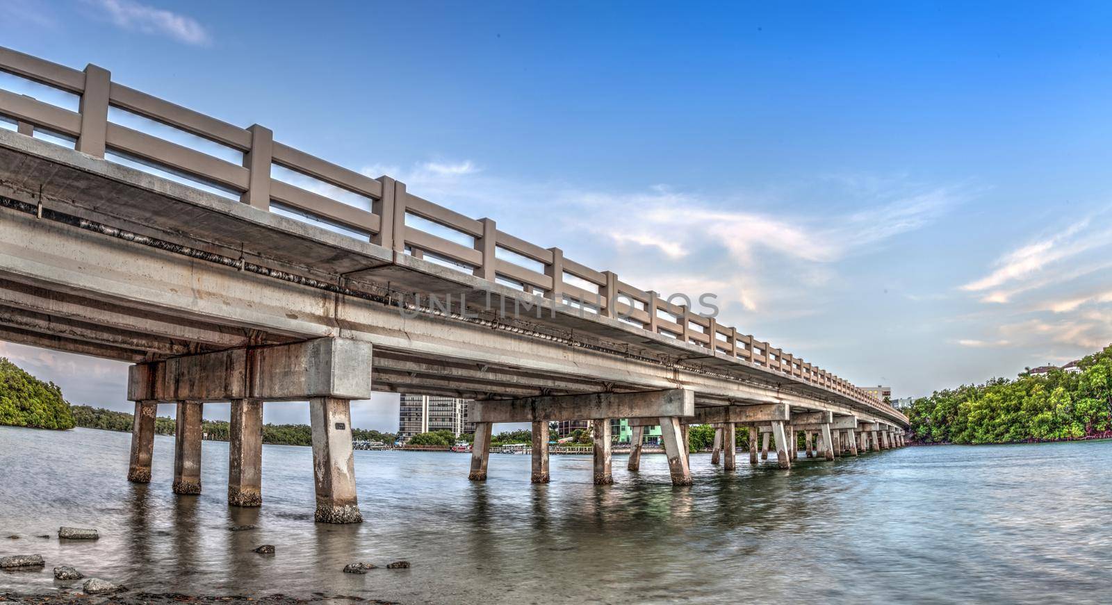 Blue sky over bridge over Hickory Pass leading to the ocean in Bonita Springs, Florida.