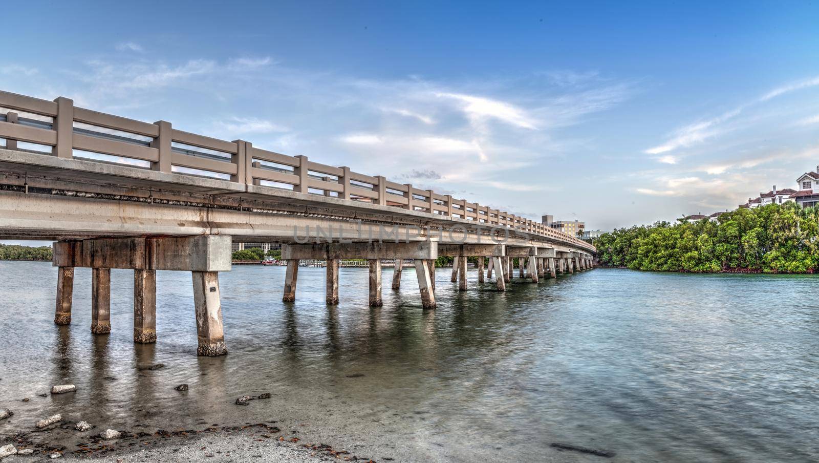 Blue sky over bridge over Hickory Pass leading to the ocean in Bonita Springs, Florida.
