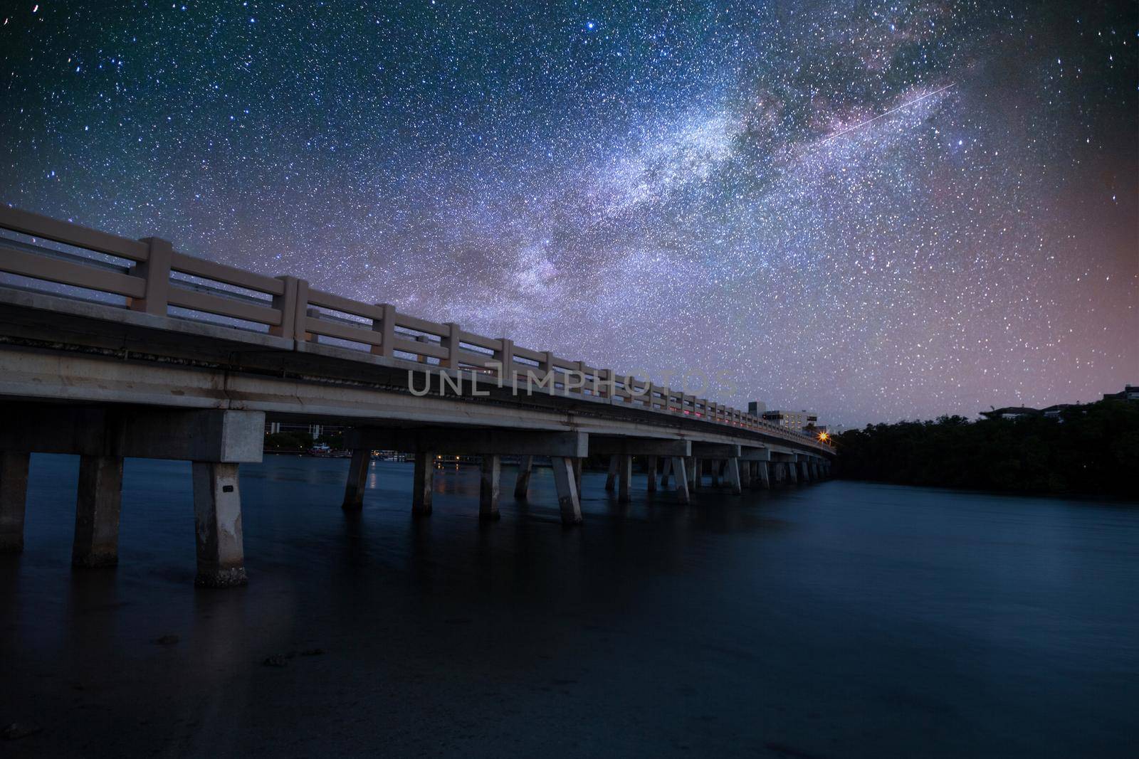 Night sky over bridge over Hickory Pass leading to the ocean in Bonita Springs, Florida.