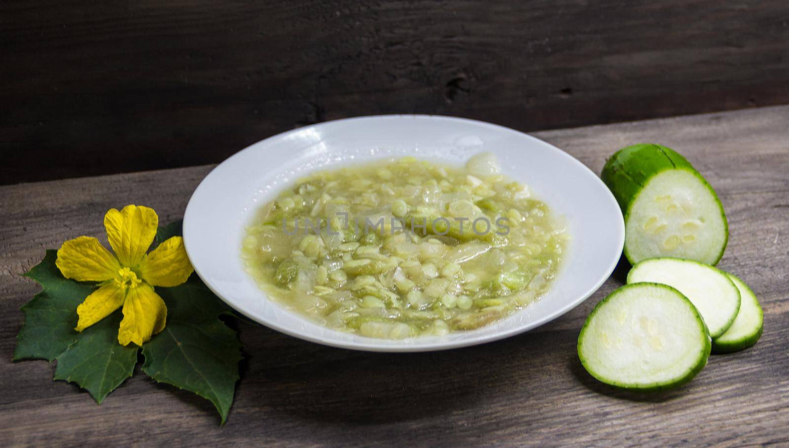 Dish of luffa or immature vegetable sponge fried with garlic and onion. Asian kitchen