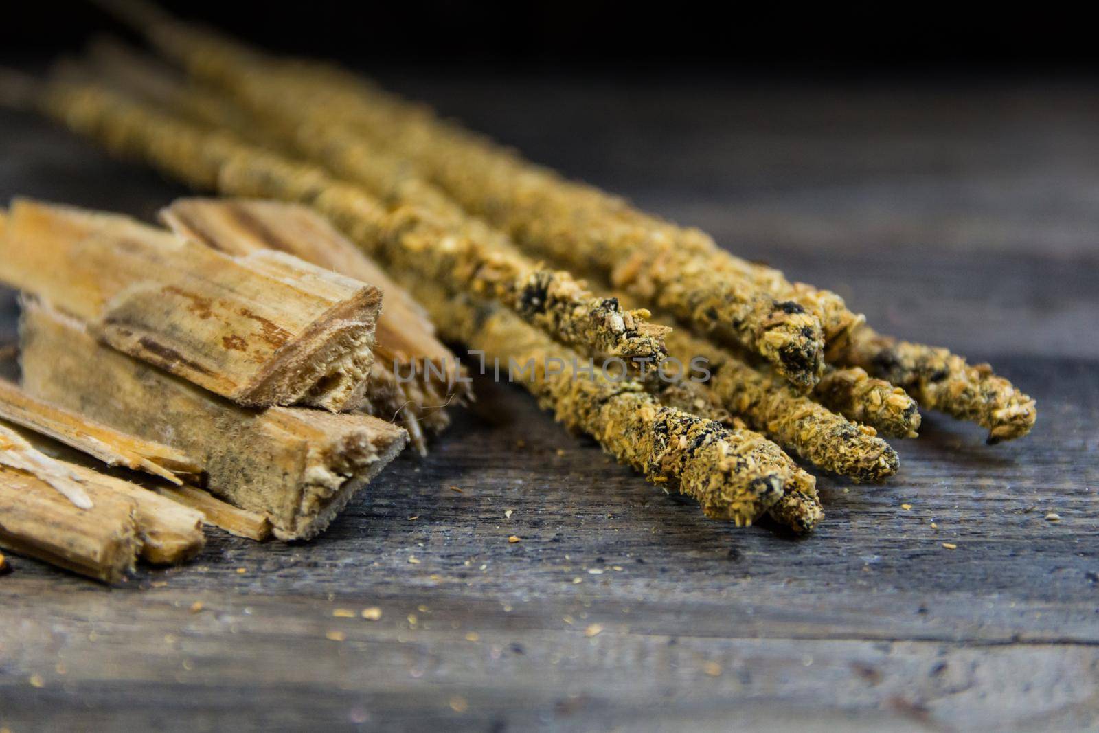close-up of handmade incense and natural ingredients on wooden background